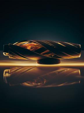 The Macallan Horizon bottle with 180 degrees twist featuring brushed aluminium casing enclosing wood, placed under lightning 