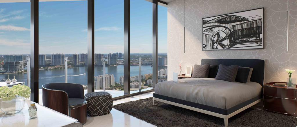 A bedroom in Bentley Miami Residence, featuring panoramic view of sky blue intercoastal water ways. 