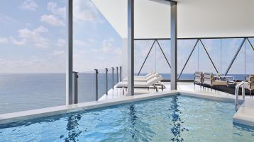 Heated swimming pool in balcony of Bentley Residences Miami , over looking vast stretch of Atlantic ocean.