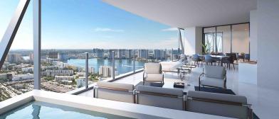 Bentley Residence Miami, with Bentley Home furniture on terrace overlooking water bodies around Sunny Isles Beach and high rise buildings. 