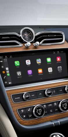 Bentley Bentayga EWB Azure's dashboard, set in Open Pore Koa veneer and Breitling clock above infotainment screen.