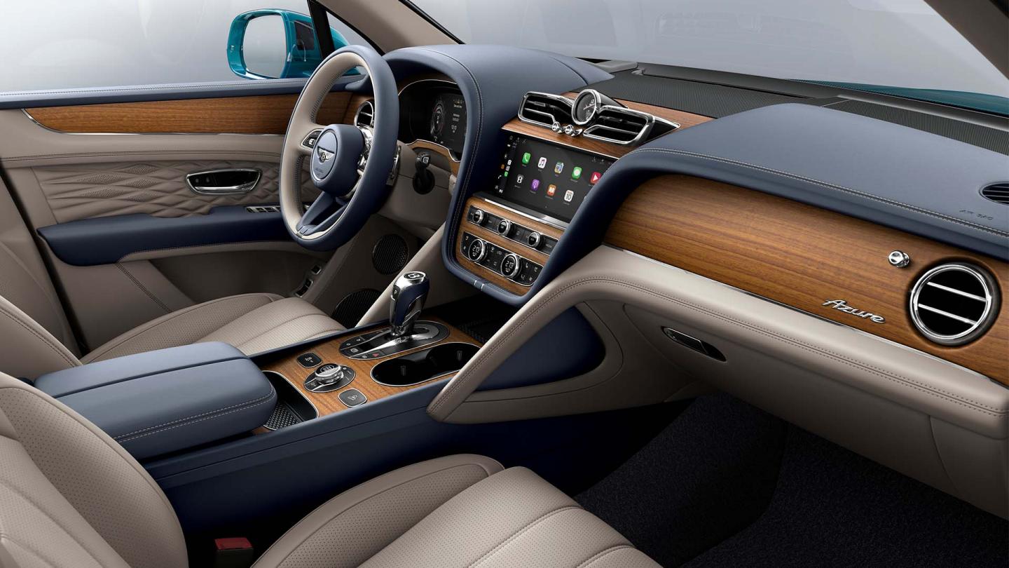 Bentley Bentayga EWB Azure interior with Open Pore Koa veneer, view from the passenger seat over looking the driver's seat. 