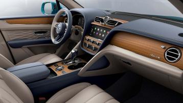 Bentley Bentayga EWB Azure interior with Open Pore Koa veneer, view from the passenger seat over looking the driver's seat. 