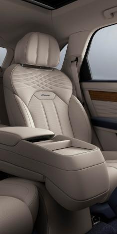 Bentley Bentayga EWB Azure, rear passenger seat with Bentley Airline Seat specs featuring Portland hide and Imperial blue Azure emblem.