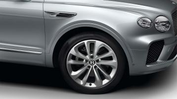 Bentley Bentayga EWB in Moonbream colour featuring 21 inch Five Twin-Spoke Wheels-Painted and lower Matt Black matrix grille.