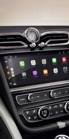 Bentley Bentayga EWB Mulliner's dashboard, featuring Grand Black veneer with Mulliner Overlays and Breitling clock above infotainment screen.