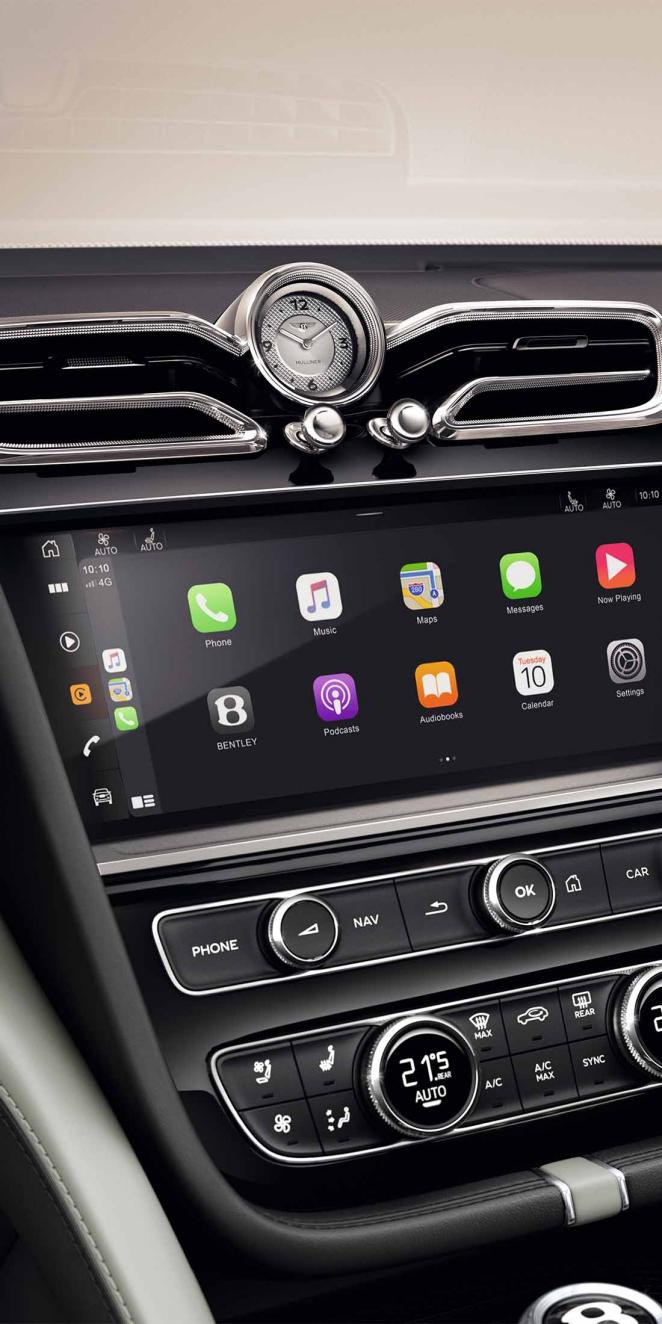 Bentley Bentayga EWB Mulliner's dashboard, featuring Grand Black veneer with Mulliner Overlays and Breitling clock above infotainment screen.