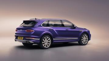 Rear side angled view of Bentley Bentayga EWB Mulliner in Tanzanite Purple colour featuring 22 inch Mulliner Wheel - Polished. 