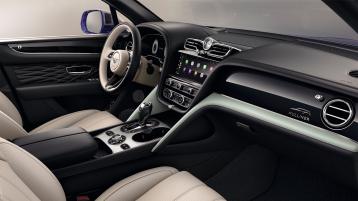 View over looking driver's seat of Bentley Bentayga EWB Mulliner, featuring Grand Black veneer with Mulliner Overlays and Aluminium Console.