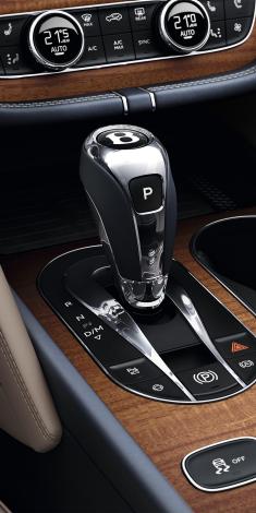 Bentley Bentayga Azure's 8 speed automatic transmission lever in focus set in Open Pore Koa veneer.