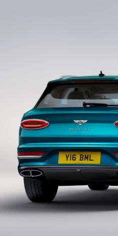 Rear view of Bentley Bentayga Azure in Topaz Blue colour with black painted shark fin aerial and fixed rear spoiler.