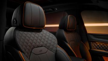 Close up of Bentayga S Black Edition seat embroidery featuring mandarin accents