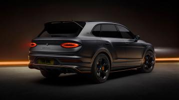 Bentley Bentayga S Black Edition rear 3/4 featuring 22 inch S directional wheel - Black Painted and Polished as well as Mandarin accents on the styling kit