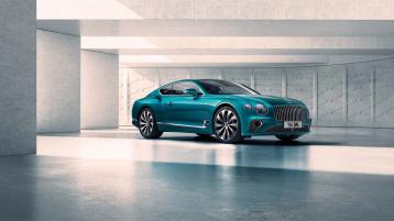 Side angled view of Bentley Continental GT Azure V8 in Topaz Blue featuring 22" Ten Spoke Wheel - Black Painted & Bright Machined parked indoors.