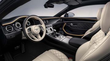 View over looking driver's seat of Bentley Continental GT Mulliner featuring Heated, Duo-Tone, 3 Spoke, Hide Trimmed Steering Wheel with Piano Black Veneer.