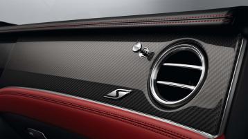 Bentley Continental GT Speed rear seats featuring Beluga hide contrasted by Mandarin piping and contrast Speed Emblem stitching. 