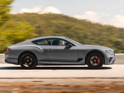 Bentley Continental GT Speed in Orange Flame featuring Dark tint radiator matrix driving along a highway.