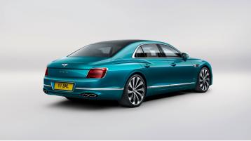 Rear side angled view of Bentley Flying Spur Azure V8 in Topaz Blue colour 22 inch Ten Spoke Wheel, Black Painted and Bright machined wheels.