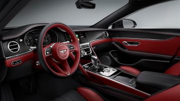 Bentley Flying Spur Speed W12, driver side view overlooking passenger seat, featuring Mandarin hide and High Gloss Carbon fibre veneer.