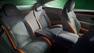 The rear cabin of the new hybrid Bentley Continental GT Speed with a exclusive Speed colour split with Gravity Grey main hide and Mandarin secondary hide