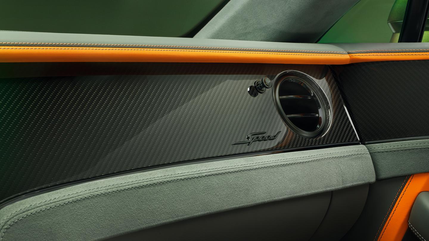 Close up of the fascia in the new hybrid Bentley Continental GT Speed featuring Mandarin accents and Black Chrome Interior Specification