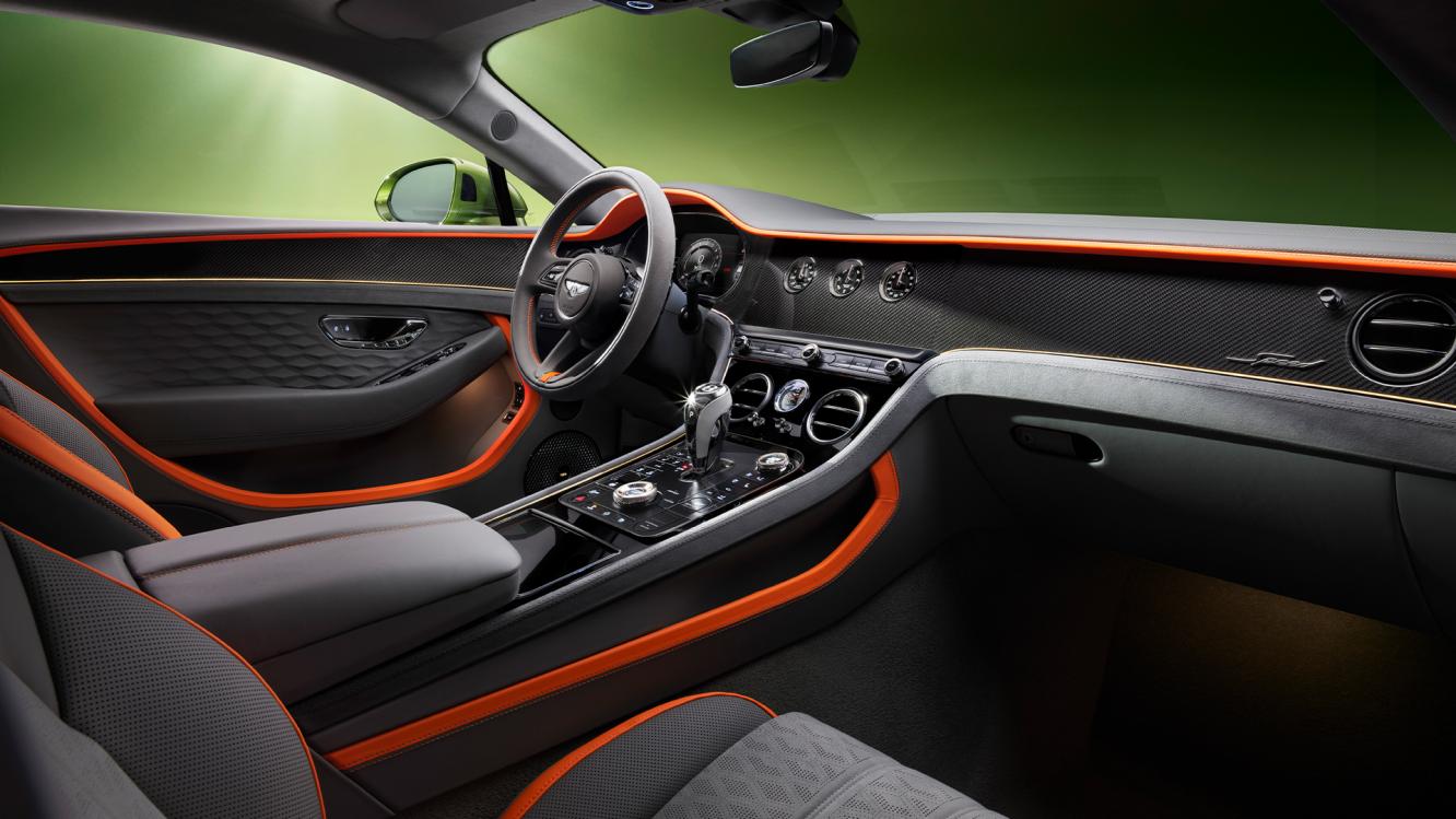 The front cabin of the new hybrid Bentley Continental GT Speed with a exclusive Speed colour split with Gravity Grey main hide and Mandarin secondary hide