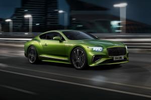 New Continental GT Speed in Tourmaline Green with 21 inch directional Speed wheels driving in an urban environment