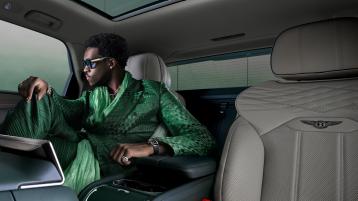 Wisdow Kaye sitting in the rear cabin of the Bentayga Atelier Edition featuring cross stitching and cumbrian green pipping