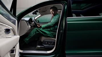 Wisdom Kaye in the drivers seat of the Bentayga Atelier Edition overlooking the illuminated threadplate