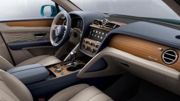 Bentley Bentayga EWB Azure interior with Open Pore Koa veneer, view from the passenger seat over looking the driver's seat. 
