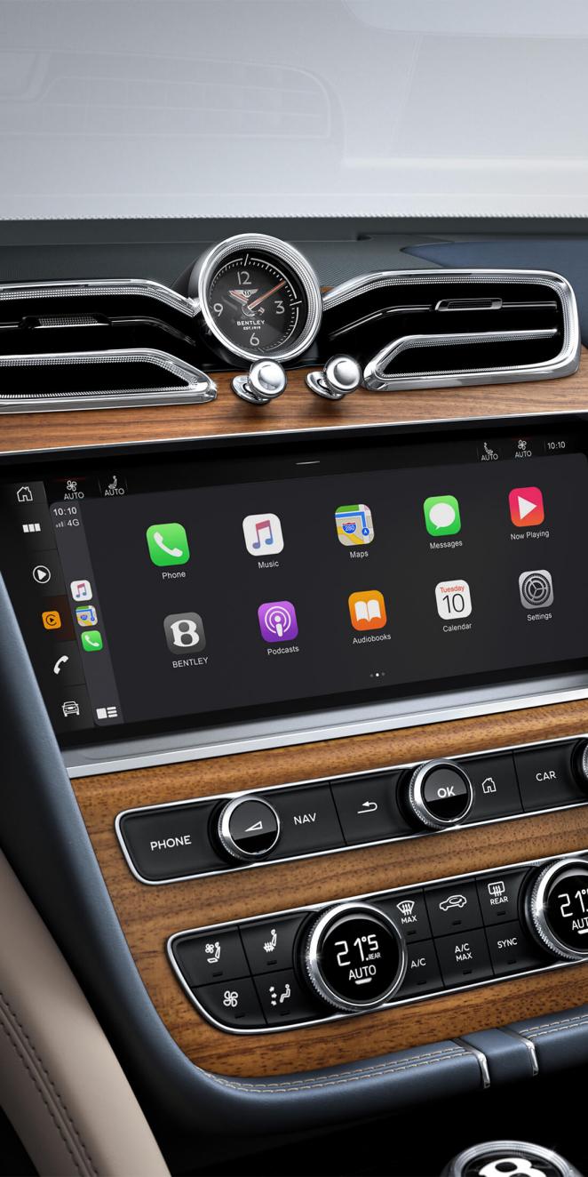 Bentley Bentayga EWB Azure's dashboard, set in Open Pore Koa veneer and Breitling clock above infotainment screen.