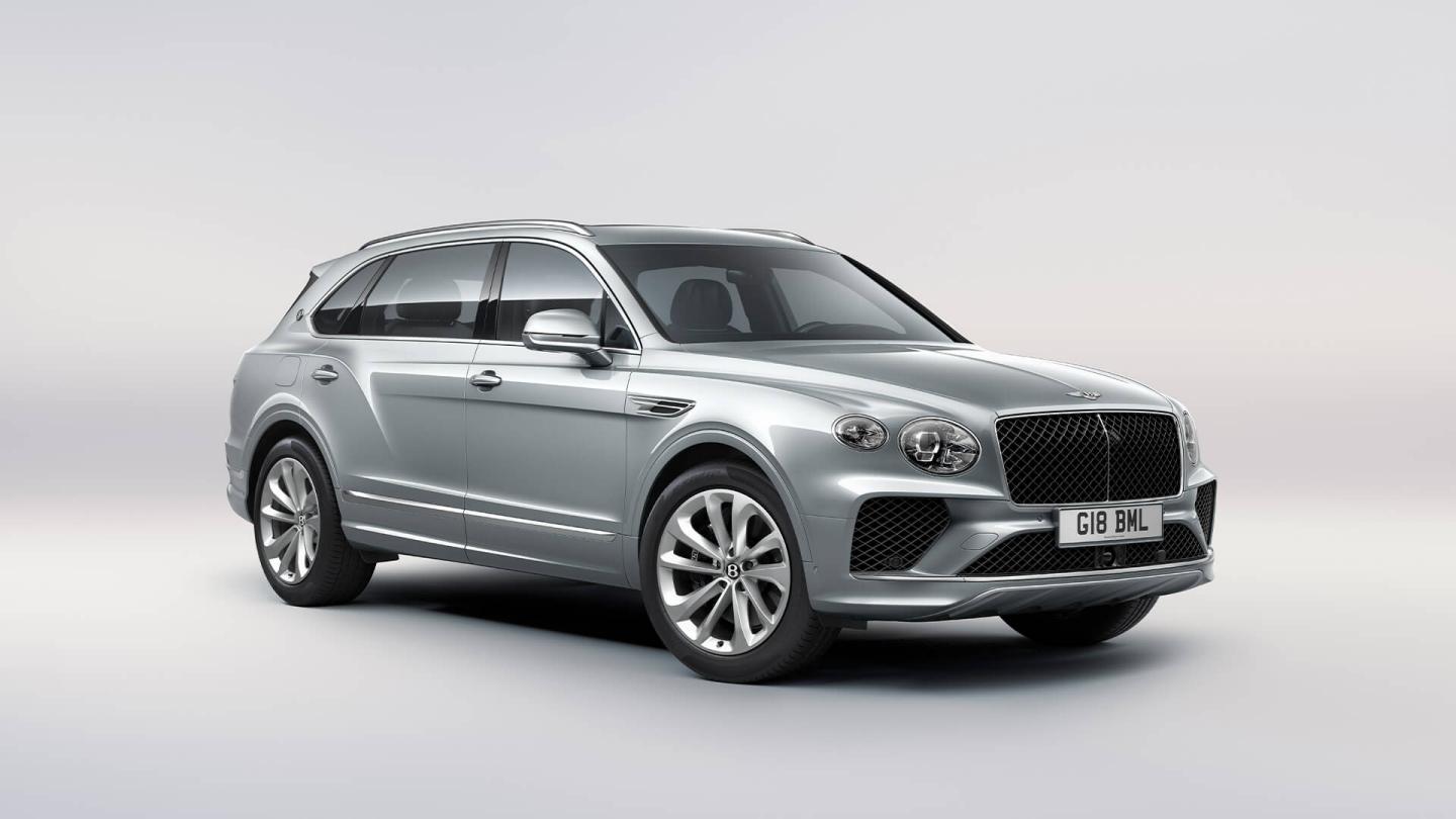 Bentley Bentayga EWB in Moonbeam paint, front three-quarter view, featuring a matrix grille and elliptical jewel cut LED headlights.