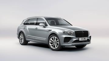 Bentley Bentayga EWB in Moonbeam paint, front three-quarter view, featuring a matrix grille and elliptical jewel cut LED headlights.