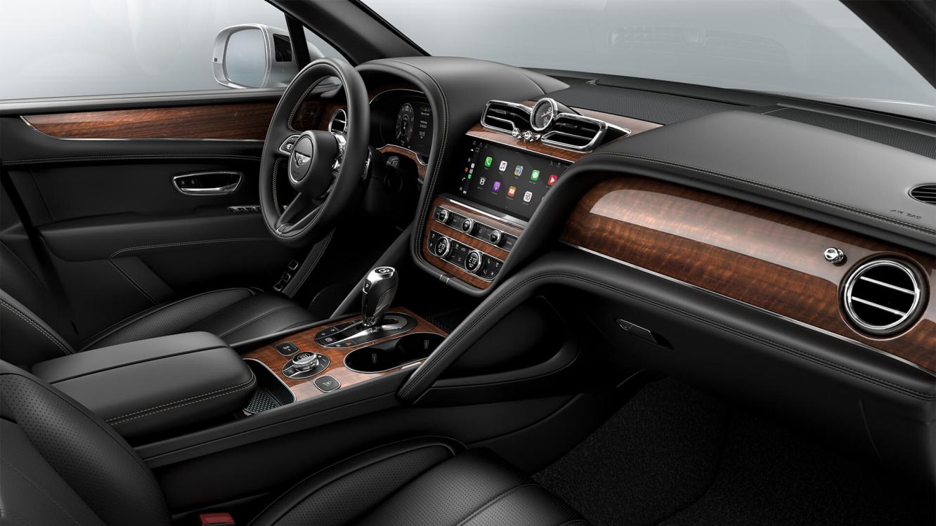 Bentley Bentayga EWB interior with a Crown Cut Walnut veneer, view from the passenger seat over looking the driver's seat.