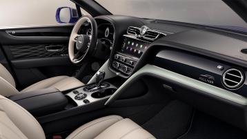 "View over looking driver's seat of Bentley Bentayga EWB Mulliner, featuring Grand Black veneer with Mulliner Overlays and Aluminium Console. "