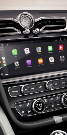 Bentley Bentayga EWB Mulliner's dashboard, featuring Grand Black veneer with Mulliner Overlays and Breitling clock above infotainment screen.