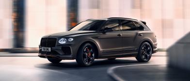 Bentley Bentayga S in Cambrian Grey colour, driving along urban setting featuring 22 inch S Directional Wheel - Black Painted and Polished.