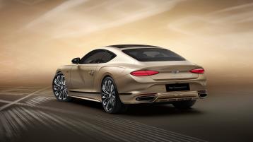 Rear three quarter  of the new hybrid Bentley Continental GT Mulliner with a Patina exterior colour and exclusive Mulliner 22" directional wheels