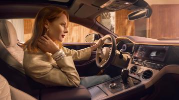 Model sitting in the drivers seat of the new Bentley Continental GT Mulliner with linen main hide and Damson secondary hide