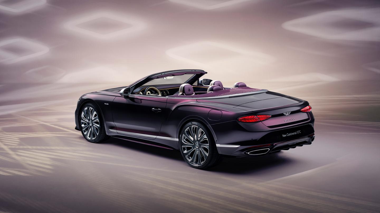 Rear three quarter of the new hybrid Continental GTC Mulliner in Damson Green 22 inch directional and diamond cut Mulliner wheels