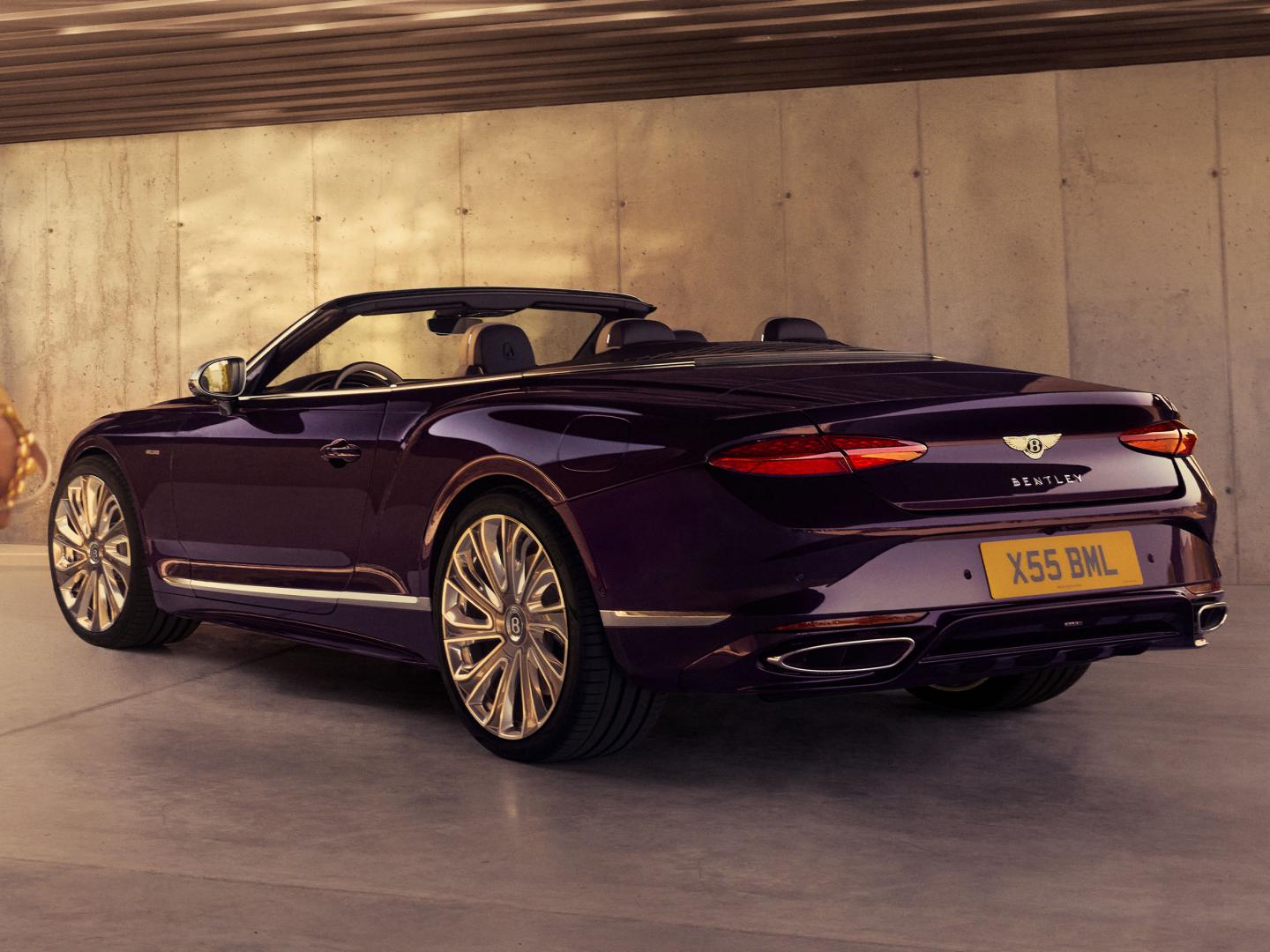 Rear three quarter of the new hybrid Bentley Continental GTC Mulliner with Damson exterior colour and 22" directional Mulliner wheels