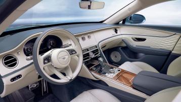 Driver side view of Bentley Flying Spur Azure V8 overlooking passenger side, featuring Portland hide and Open Pore Koa veneer.