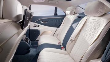 Rear passenger seats of Bentley Flying Spur Azure V8 with Azure emblem in main Portland Hide and Imperial Blue Azure emblem secondary hide featuring 4 seat configuration.