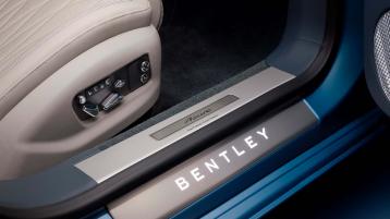 Bentley Flying Spur Azure V8, side one quarter view with chrome accents and featuring 22 inch ten spoke wheels - black painted and machined