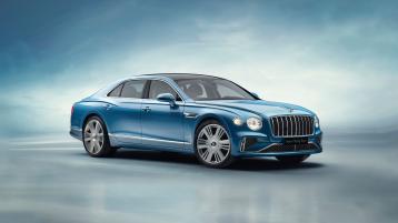 Front side angled view of Bentley Flying Spur Azure V8 in Topaz Blue colour, featuring 22 inch Ten Spoke Wheel - Black Painted and radiator mascot – bright polished steel