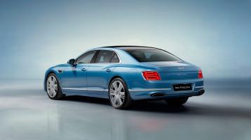 Rear side angled view of Bentley Flying Spur Azure V8 in Topaz Blue colour 22 inch Ten Spoke Wheel, Black Painted and Bright machined wheels.