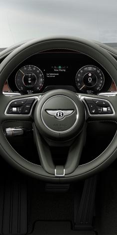 Drivers view of the steering wheel and drivers display in the new hybrid Flying Spur