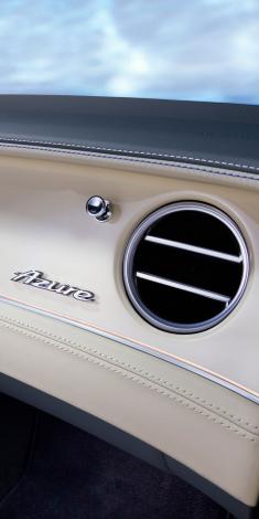 Centre console of Bentley Continental GTC Azure V8 set in Open Pore Koa veneer with 8 speed dual clutch tranmission lever in view.