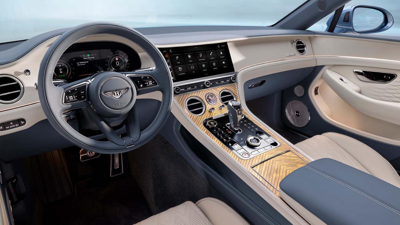 The front cabin of the new hybrid Continental GT Azure featuring white piano veneer, linen main hide and a dark blue secondary hide