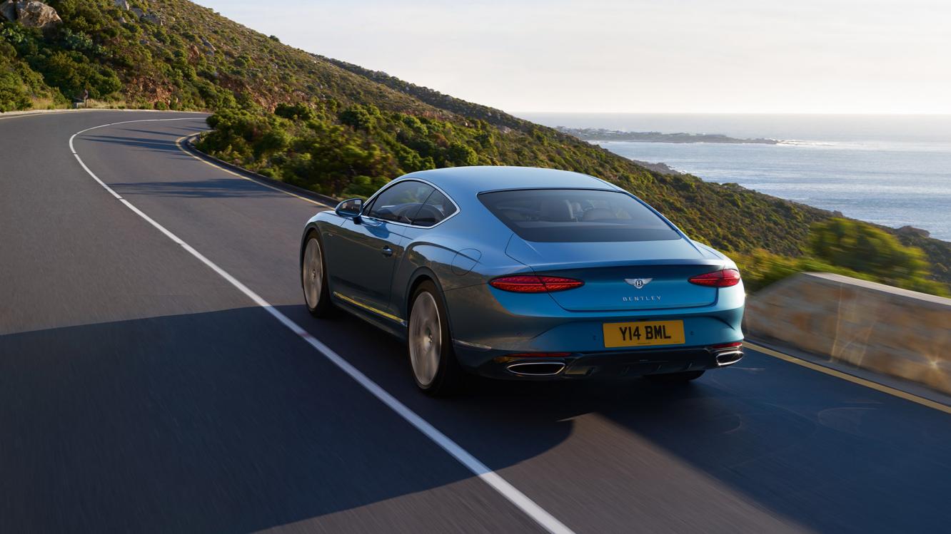 Rear three quarter of the new hybrid Bentley Continental GT Azure with a Light Windsor Blue exterior colour and exclusive Azure 22" wheels